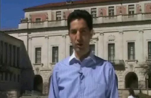 VOA news reporter standing in front of UT tower, Main Building
